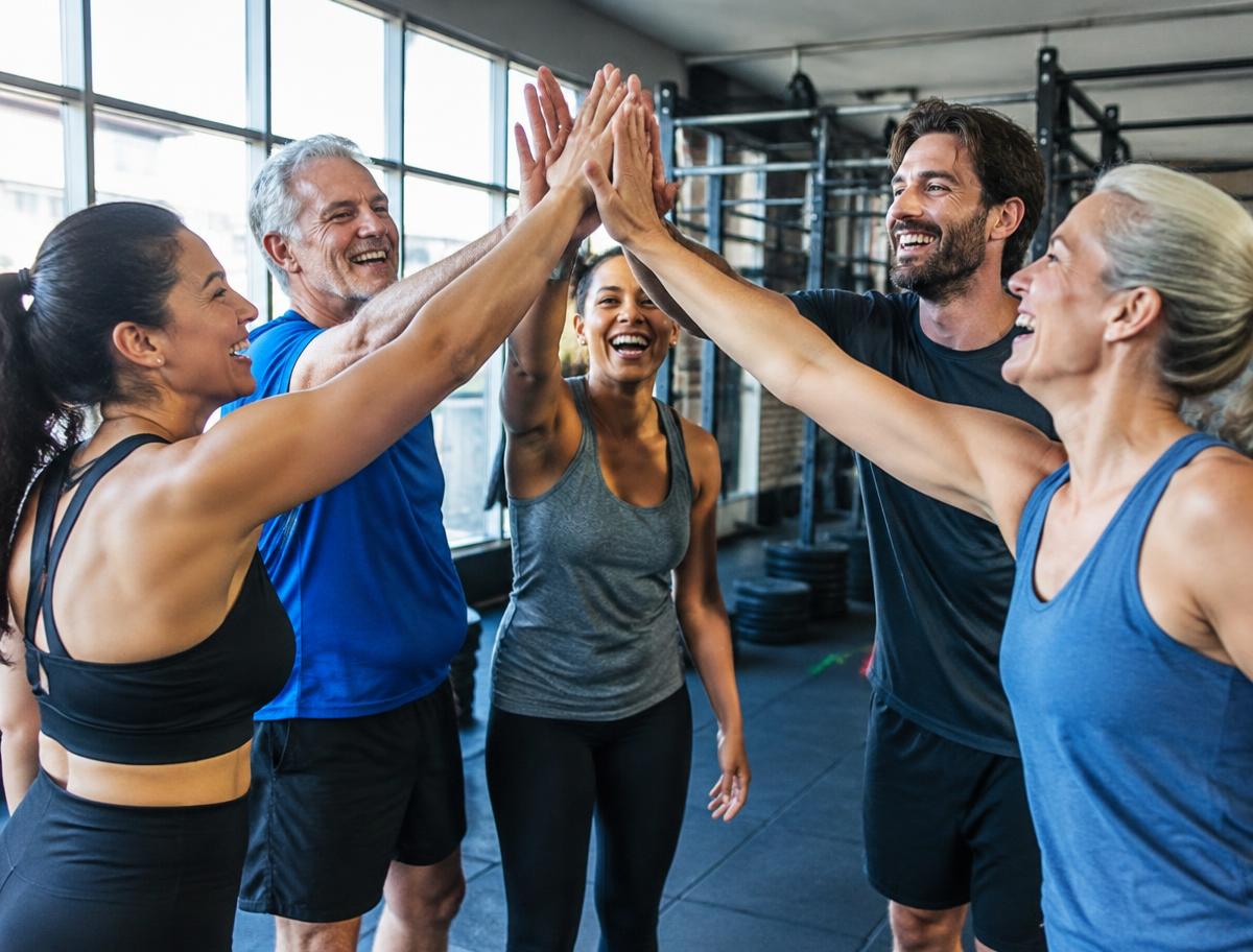 Members high-fiving after a group workout